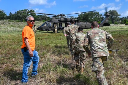 Kjäll Gopaul, Department of Defense senior civilian pathfinder, directs U.S. Air Force personnel during simulated medical evacuation procedures for OPERATION DUSTOFF VIGILANCE ’25 at Joint Base San Antonio-Camp Bullis, Texas, July 16, 2025.