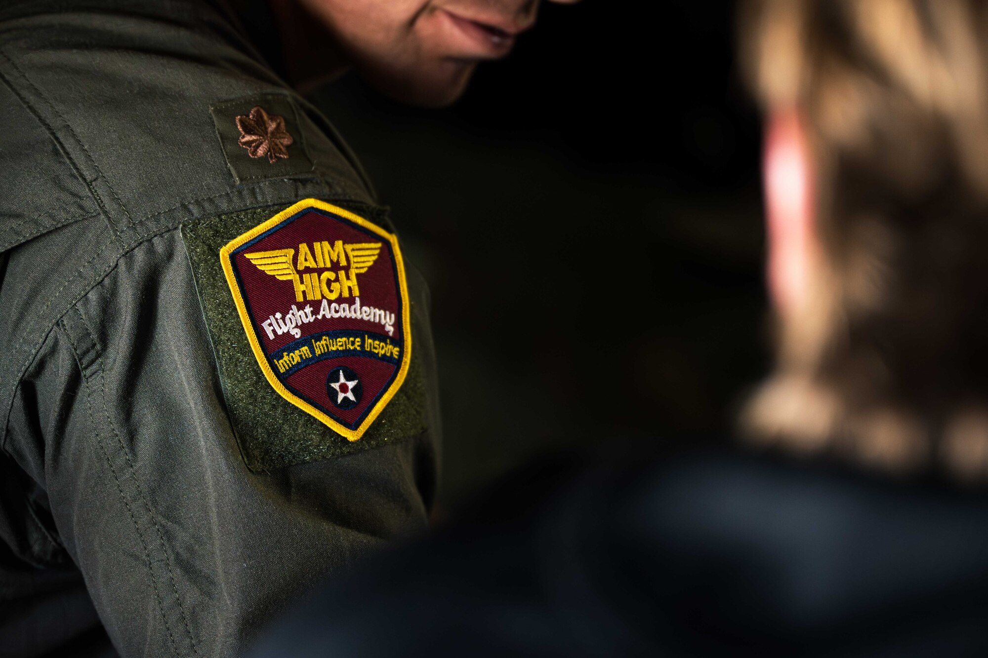 U.S. Air Force Maj. Jonathon Taylor, 558th Flying Training Squadron assistant director of operations, displays the Aim High Flight Academy (AHFA) patch at Altus Air Force Base, Oklahoma