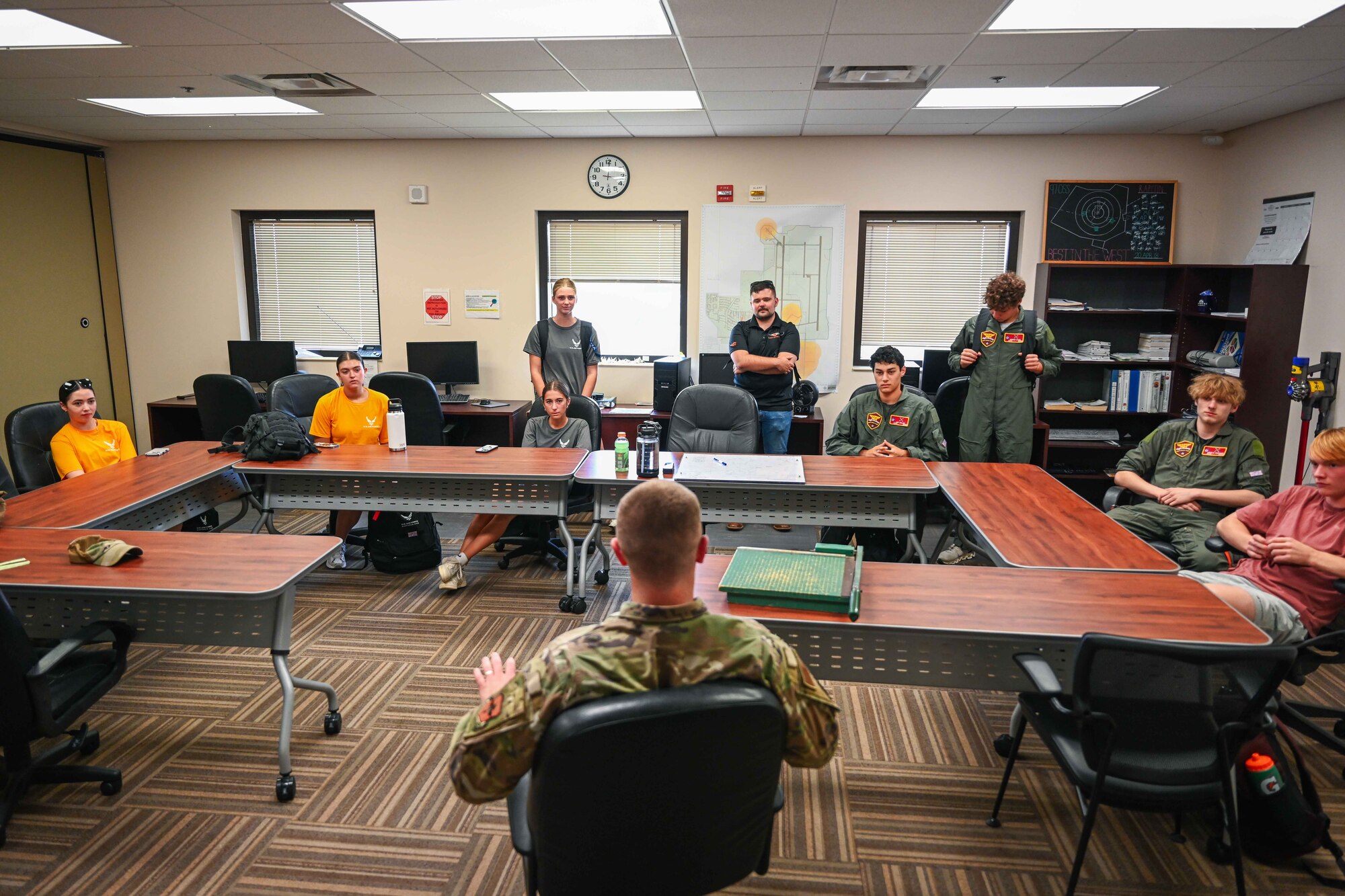 Aim High Flight Academy students speak with 2nd Lt. John Marrah, 97th Operations Support Squadron Air Field Operations Flight commander, at Altus Air Force Base, Oklahoma