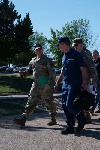 U.S. Air Force Col. Jason Gerber, 17th Training Group commander, briefs U.S. Coast Guard Rear Adm. Greg Rothrock, U.S. Cyber Command J7 Director of Force Development, during a walking tour to the 316th Training Squadron at Goodfellow Air Force Base, Texas, May 20, 2025. The walking tour showcased the cryptologic training campus and classrooms while providing detailed information on the training capabilities of the 17th TRG. (U.S. Air Force photo by Airman 1st Class Brian Lummus)