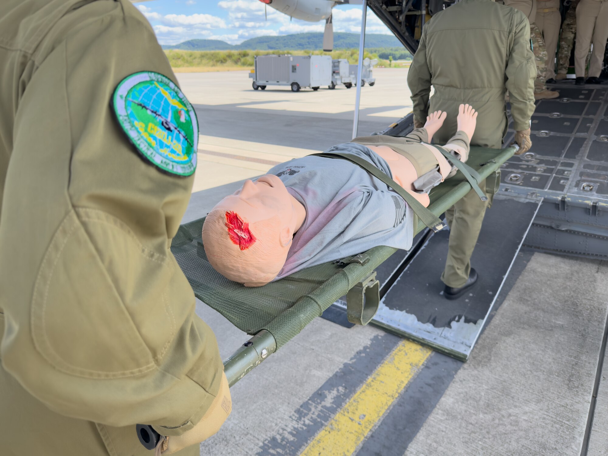 Algerian military personnel conduct a litter carry with a medical mannequin onto a static C-130 Hercules aircraft during an Algerian aeromedical evacuation familiarization visit at Ramstein Air Base, Germany, July 17, 2025. The familiarization visit, led by the U.S. Air Forces in Europe – Air Forces Africa Command Surgeon’s Office of Global Health Engagements and the 86th Aeromedical Evacuation Squadron, provided an opportunity to exchange aeromedical training and best practices, serving as a foundation for future military healthcare cooperation.