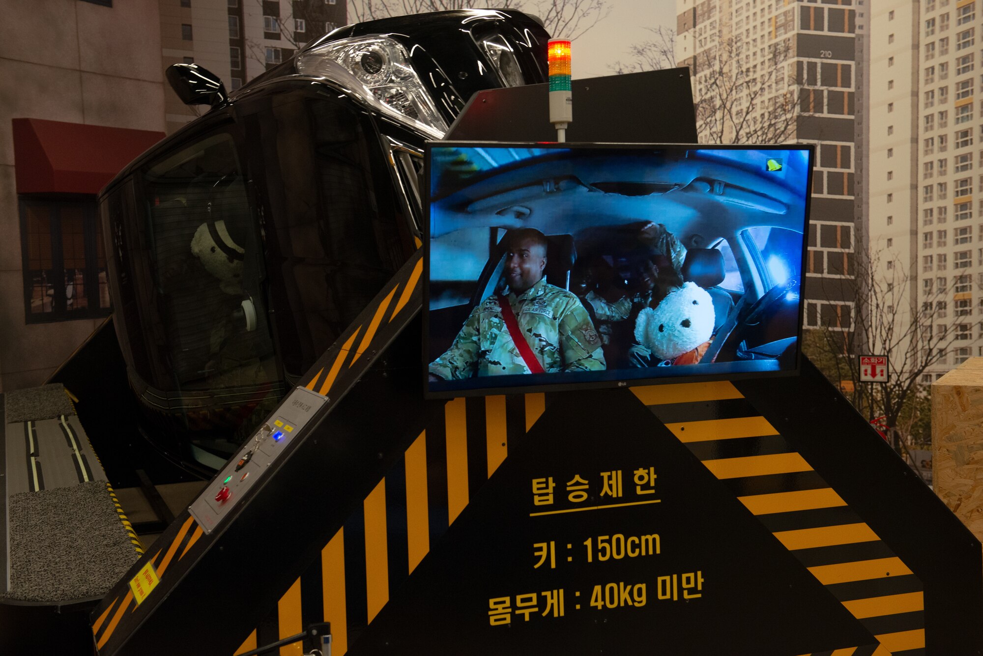 Airmen experience a car roll-over in a simulator demonstrating the importance of seatbelts.
