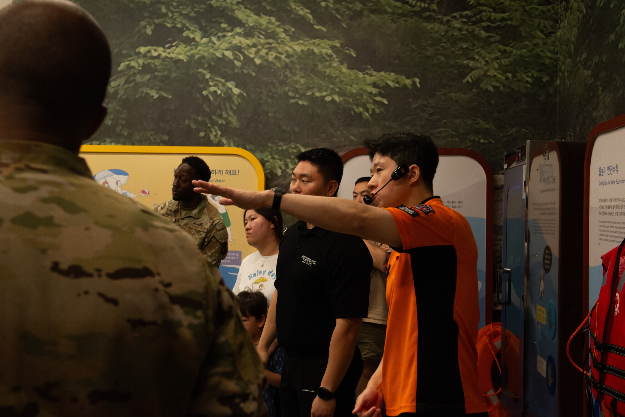 A Korean safety center educator briefs Airmen on wilderness disaster responses.