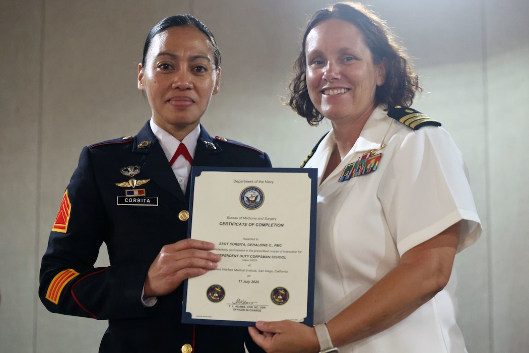 Cmdr. Tuesday Adams, officer in charge of the Surface Warfare Medical Institute (SWMI), presents Philippine Marine Staff Sgt. Geraldine Corbita with her Independent Duty Corpsman certificate of completion during a graduation ceremony at the Surface Warfare Medical Institute (SWMI) in San Diego, July 11, 2025. Corbita, of Zamboanga Philippines, is the first Philippine Navy Marine corpsman to earn the qualification, a milestone signaling a strengthened alliance between the U.S. and the Armed Forces of the Philippines (AFP). (U.S. Navy photo by Arsenio R. Cortez Jr.)