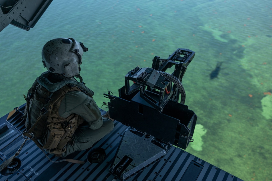 U.S. Marine Corps Staff Sgt. Fred Miller, from Nevada, a CH-53K King Stallion crew chief with Marine Heavy Helicopter Squadron (HMH) 461, looks out of a CH-53K near Naval Air Station Key West, Florida, July 21, 2025. Marines with 2nd Marine Aircraft Wing and 2nd Distribution Support Battalion are training with elements of the U.S. Army, U.S. Navy, and U.S. Customs and Border Protection to refine humanitarian assistance and disaster relief capabilities while also refining the CH-53K’s ability to support distributed aviation operations in a joint environment. (U.S. Marine Corps photo by Cpl. Mya Seymour)