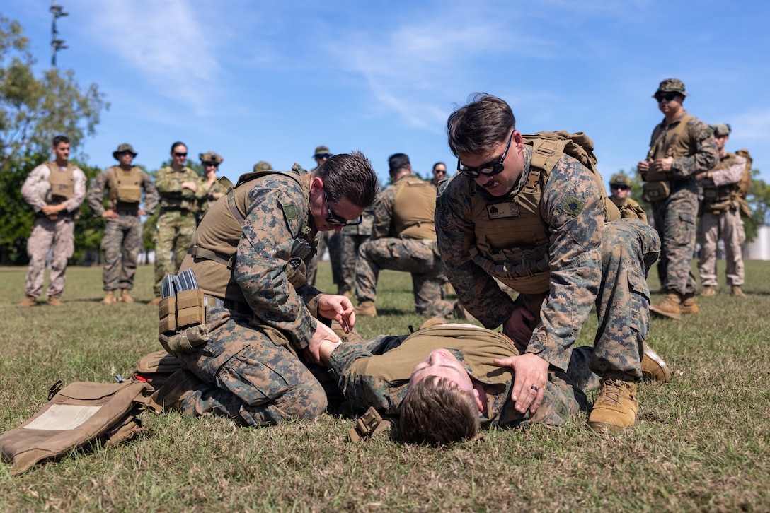 U.S. Navy Sailors and Marines with Marine Rotational Force – Darwin 25.3 and Australian soldiers with 1st Health Battalion, conduct tactical combat casualty care at Robertson Barracks, Darwin, Australia, June 25, 2025. MRF-D is an annual six-month rotational deployment to enhance interoperability with the Australian Defence Force and allies and partners and provide a forward-postured crisis response force in the Indo-Pacific. (U.S. Marine Corps photo by Cpl. Keegan Jones)