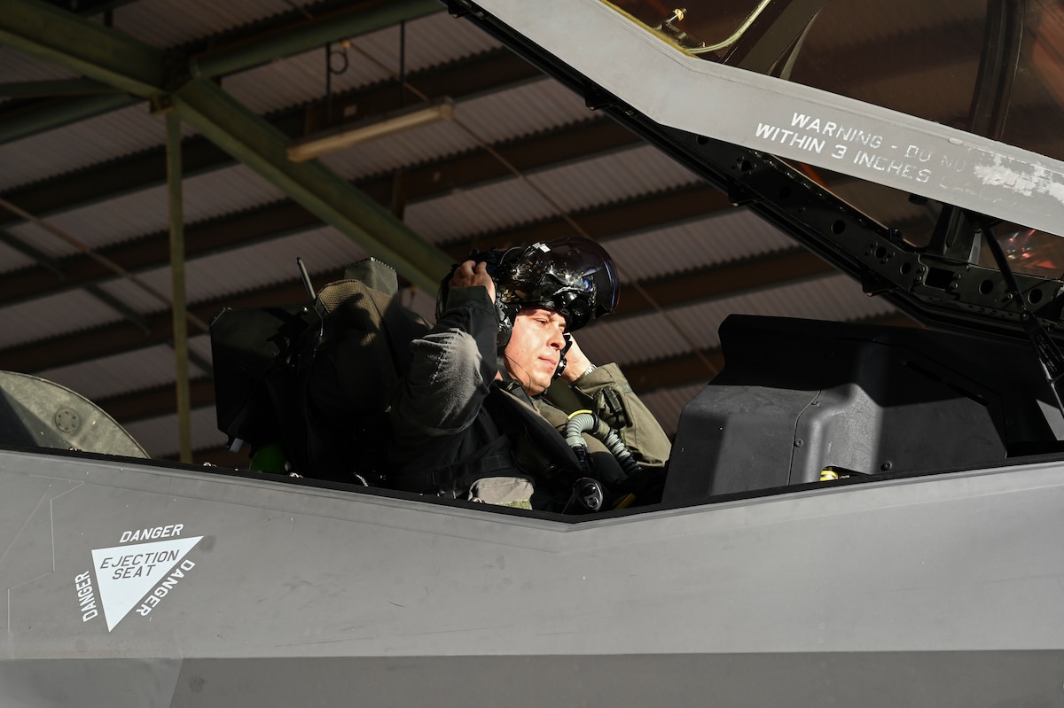 U.S. Air Force Maj. Colby “Burn” Kluesner, 388th Fighter Wing F-35A Lightning II evaluator pilot, dons his helmet prior to take off in a Royal Australian Air Force F-35A during Talisman Sabre 25 in Northern Territory, Australia, July 16, 2025. Talisman Sabre is the largest bilateral military exercise between Australia and the United States, that advances a safe and secure Indo-Pacific by strengthening relationships and interoperability among key allies and partners, while enhancing our collective capabilities to respond to a wide array of potential security concerns. (U.S. Air Force photo by Airman 1st Class Joseph Maye)