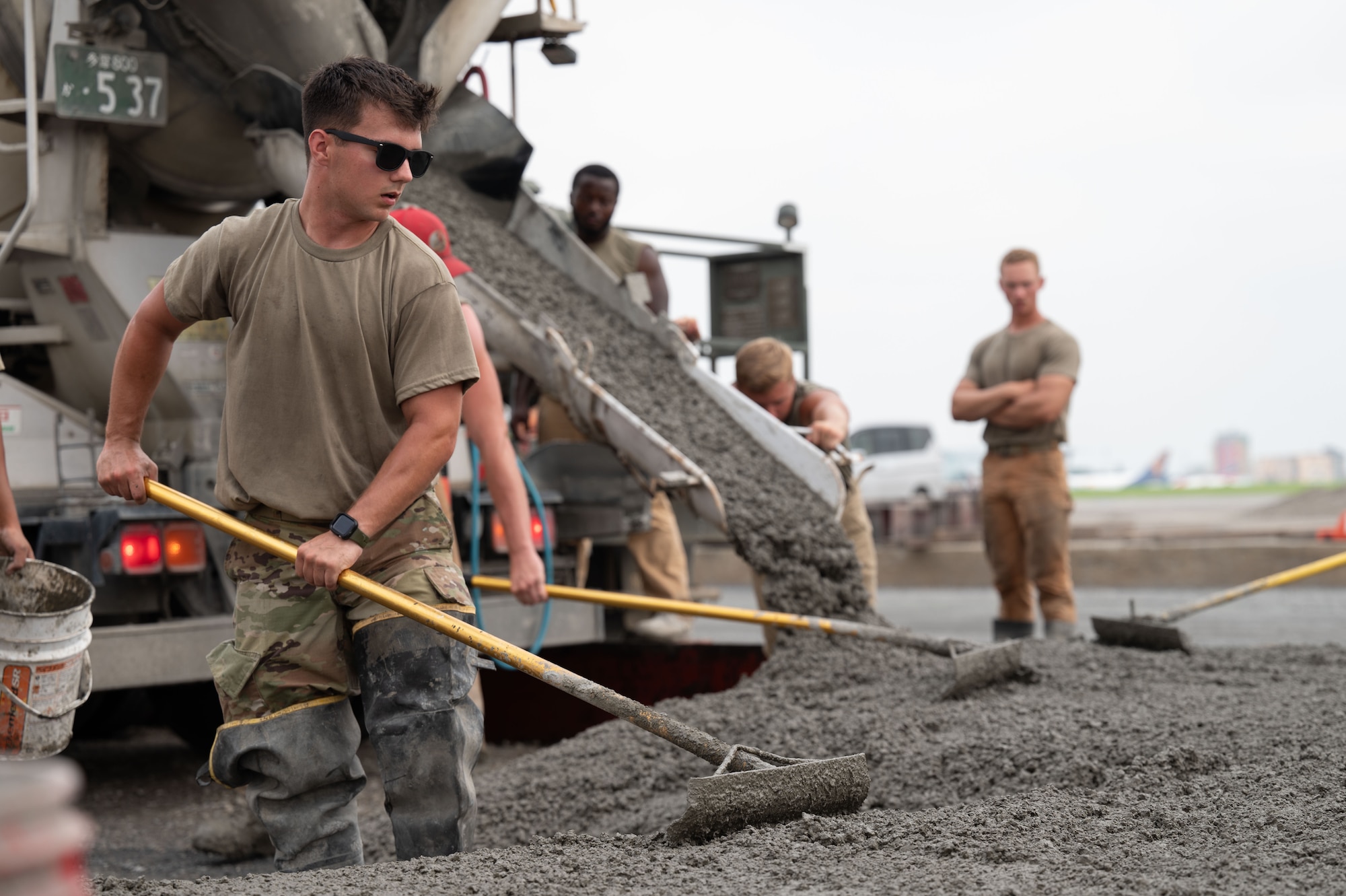Airman pushes concrete.