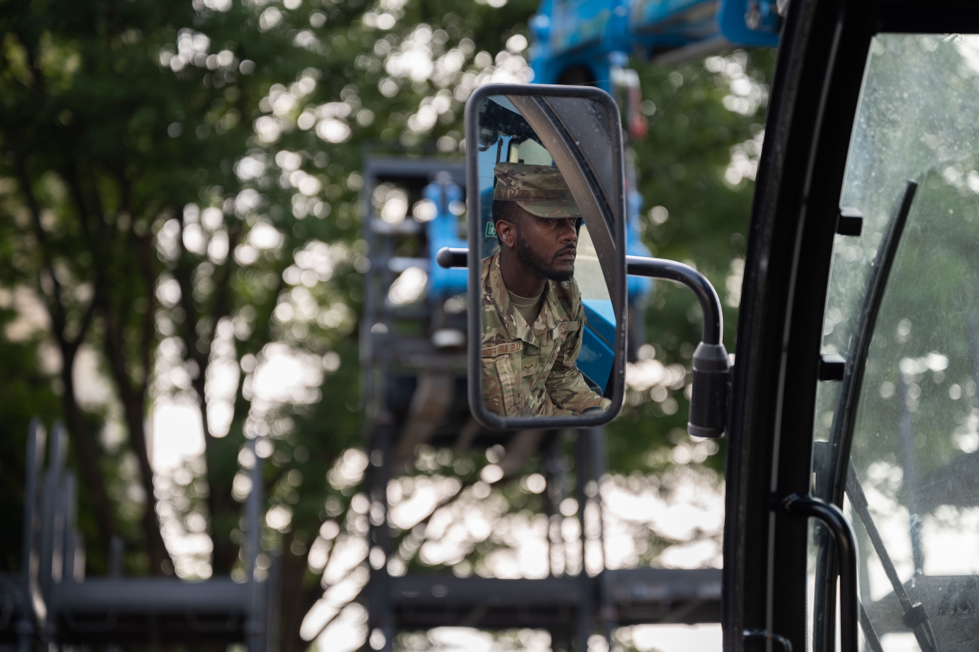 Airman drives a tele-handler.