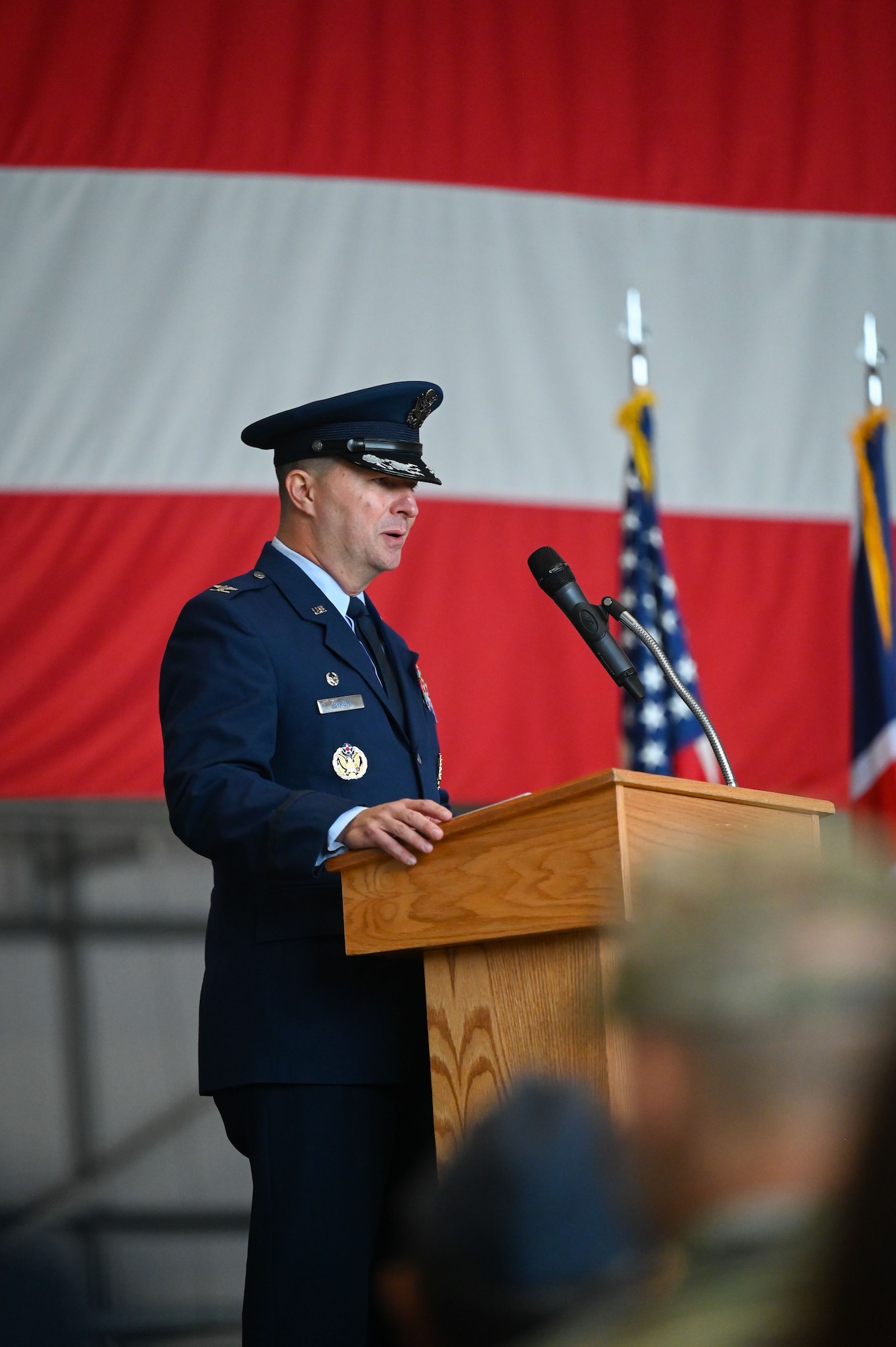 U.S. Air Force Col. Steven Bryrum, 100th Air Refueling Wing incoming commander, addresses the audience during the 100th ARW change of command ceremony at Royal Air Force Mildenhall, England, July 22, 2025.