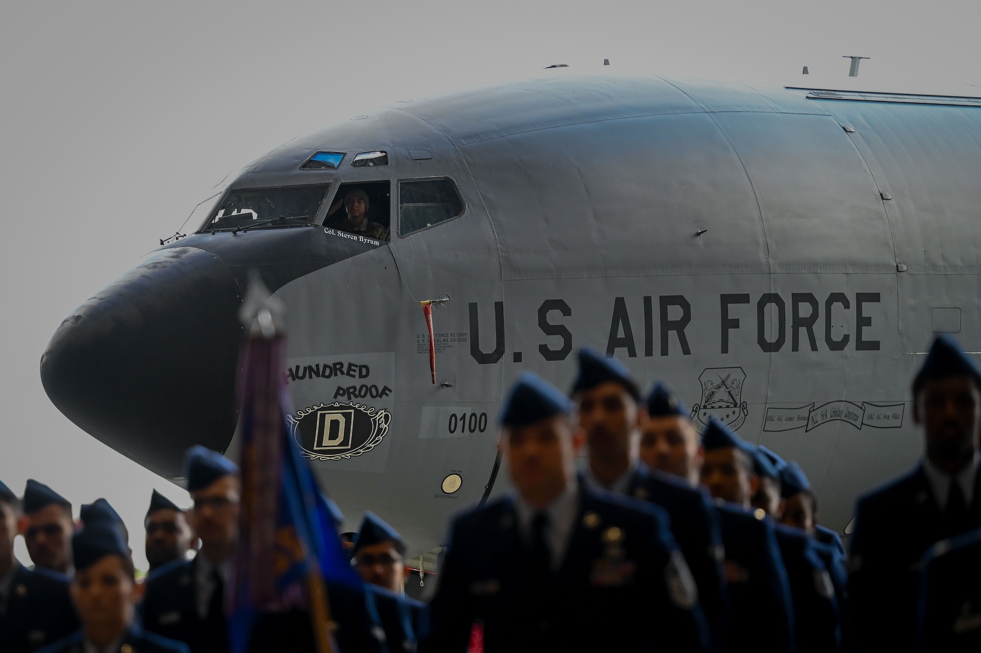 U.S. Air Force Senior Airmen Christan Contreras, 100th Air Refueling Wing dedicated crew chief for aircraft 100, carries out the tradition of replacing the name on the aircraft dedicated to the wing commander during the 100th ARW change of command ceremony at Royal Air Force Mildenhall, England, July 22, 2025.
