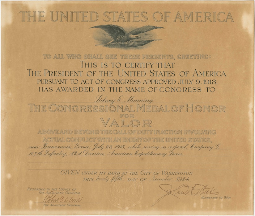 A yellowed paper certificate announces that Sidney E. Manning received the Medal of Honor.