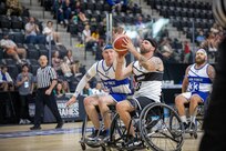 U.S. Army Retired Staff Sgt. Michael Britton drives toward the basket to take a shot during a wheelchair basketball game at the 2025 Department of Defense Warrior Games at Ed Robson Arena in Colorado Springs, Colorado, July 19, 2025.