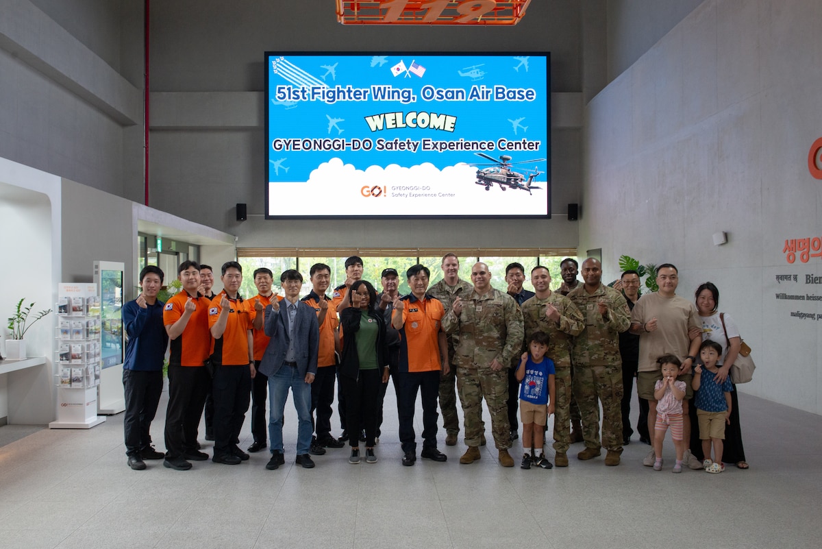 Airmen and Korean safety center employees pose for a group photo.