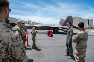 U.S. Hawaii Air National Guard Maj. Andrews Marchi, 199th Fighter Squadron F-22 Raptor pilot, speaks to multinational delegates during an International Observer Program event on Joint Base Pearl Harbor-Hickam, Hawaii, July 18, 2025. The IOP event provided the international partner delegates with insight on how they could integrate into a future Resolute Force Pacific iteration, in an effort to encourage heightened efforts in maintaining security and stability in the Indo-Pacific. (U.S. Air Force photo by Senior Airman Mark Sulaica)