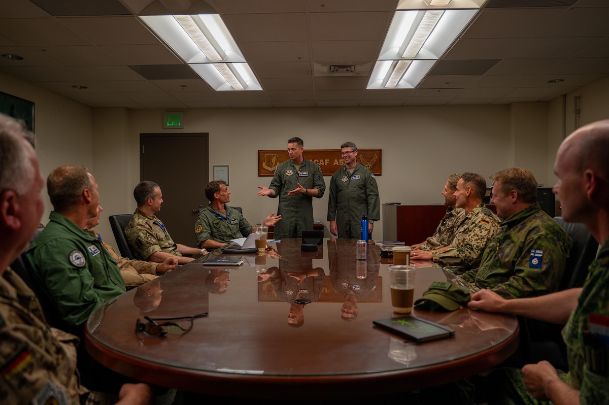 U.S. Air Force Col. Jonathan Magill (center-left), Headquarters Air Force Training and Exercise Division chief, speaks to multinational partners during an International Observer Program event at Joint Base Pearl Harbor-Hickam, Hawaii, July 18, 2025. The IOP event gave participants insight on how they could integrate into a future Resolute Force Pacific iteration to maintain stability and security and stability in the Indo-Pacific. (U.S. Air Force photo by Senior Airman Mark Sulaica)
