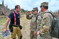 U.S. Army Capt. Stephen Landrum, right, and U.S. Army Sgt. Jason Bartram, a member of the 640th Small Unmanned Aerial Systems Detachment's Czech Republic emergency response team, takes part in flood response efforts along the Guadalupe River near Kerrville, Texas, on July 15, 2025.