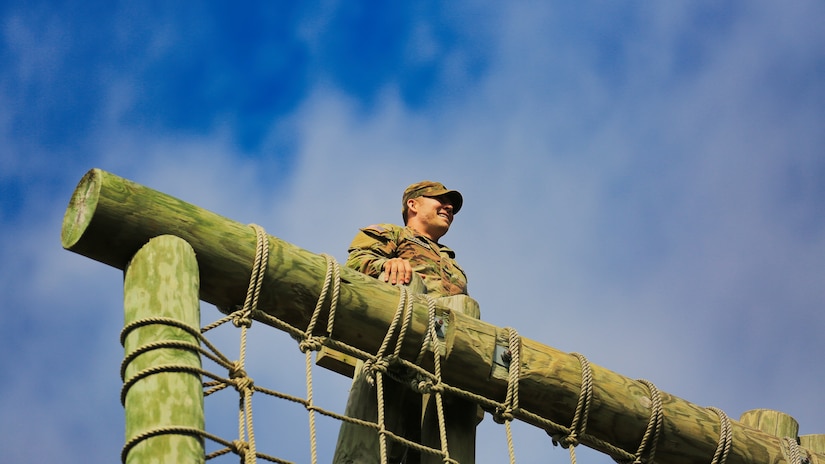 U.S. Army Dave Thomson, a public affairs specialist with the 213th Regional Support Group, Pennsylvania National Guard, scales an obstacle on the confidence course at Fort Indiantown Gap, Pennsylvania, July 22, 2025.