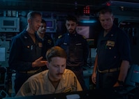 Destroyer Squadron Two Commodore, Capt. Mark Lawrence, left, speaks with Italian Navy Lt. Gabriel Petri, second from the right, a liaison officer from ITS Spartaco Schergat (F598), and other members of the DESRON-2 staff while in USS Gerald R. Ford's (CVN 78) Surface Undersea Combat Center, July 23, 2025. DESRON-2, a part of Carrier Strike Group Twelve, is currently deployed in the U.S. 6th Fleet area of operations to support the warfighting effectiveness, lethality and readiness of U.S. Naval Forces Europe-Africa, and defend U.S., Allied and partner interests in the region. (U.S. Navy photo by Mass Communication Specialist 2nd Class Mariano Lopez)