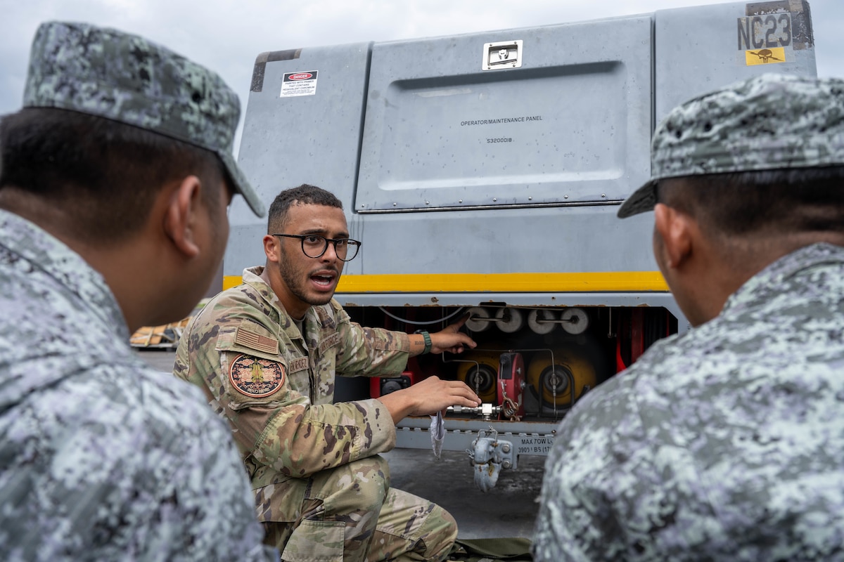 U.S. Air Force Staff Sgt. Arnaldo Puente Mendez, 421st Mission Generation Force Element aerospace ground equipment maintainer, briefs Philippine Air Force airmen on a self generating nitrogen servicing cart during Cope Thunder 25-2 at Clark Air Base, Philippines, July 9, 2025. During the subject matter expert exchange, U.S. Airmen provided valuable insight into equipment used for aircraft maintenance, supporting Armed Forces of the Philippines’ modernization efforts. (U.S. Air Force photo by Airman 1st Class Aden Brown)