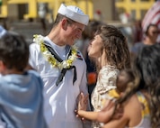 JOINT BASE PEARL HARBOR-HICKAM, Hawaii (July 22, 2025) - A Sailor assigned to the Virginia-class fast-attack submarine USS Indiana (SSN 789) greets his wife as Indiana arrives at Joint Base Pearl Harbor-Hickam during its change of homeport, July 22, 2025. Indiana is assigned to Submarine Squadron 7 and is capable of supporting various missions, including anti-submarine warfare, anti-surface ship warfare, strike warfare, and intelligence, surveillance, and reconnaissance. (U.S. Navy photo by Mass Communication Specialist 1st Class Scott Barnes)