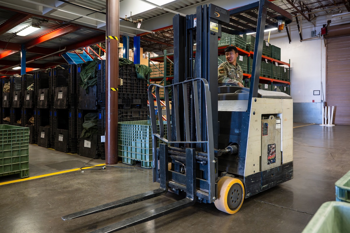 U.S. Air Force Airman 1st Class Nin-Jun Heo, 355th Logistics Readiness Squadron material manager, drives a forklift at Davis-Monthan Air Force Base, Arizona, July 22, 2025. Heo used the forklift to safely access pallets of mission-critical gear that are otherwise hard to reach. (U.S. Air Force photo by Senior Airman Jasmyne Bridgers-Matos)