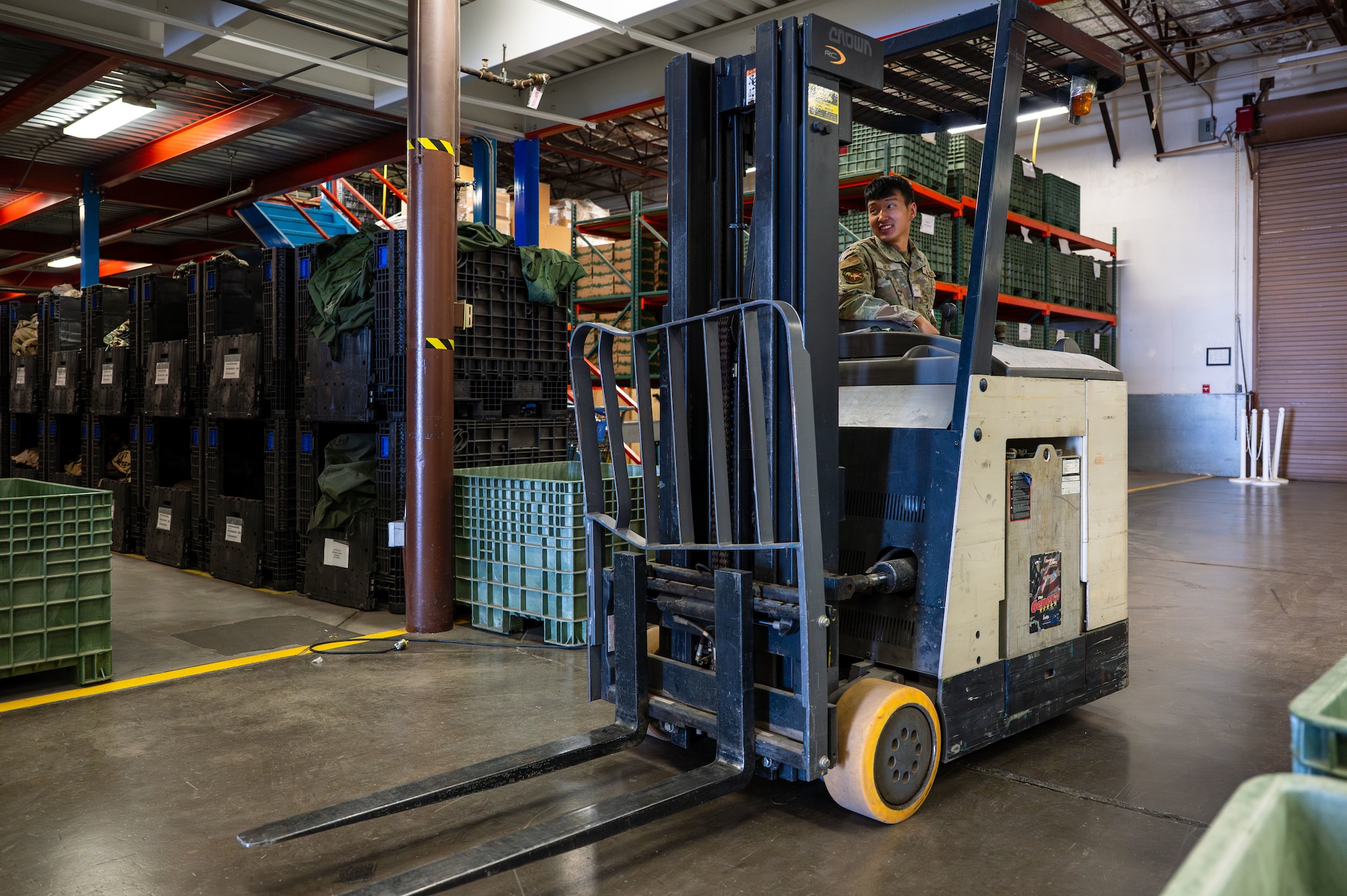 U.S. Air Force Airman 1st Class Nin-Jun Heo, 355th Logistics Readiness Squadron material manager, drives a forklift at Davis-Monthan Air Force Base, Arizona, July 22, 2025. Heo used the forklift to safely access pallets of mission-critical gear that are otherwise hard to reach. (U.S. Air Force photo by Senior Airman Jasmyne Bridgers-Matos)
