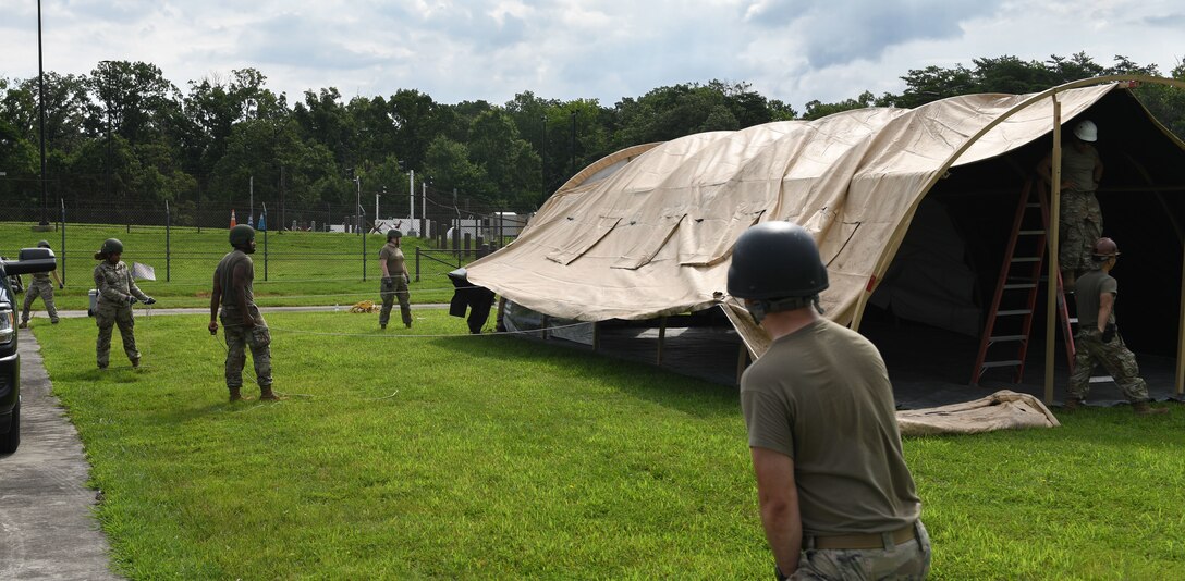 U.S. Airmen assigned to the Air Force District of Washington set up a tent during AFDW Readiness Day at Joint Base Andrews, Md., July 18, 2025.