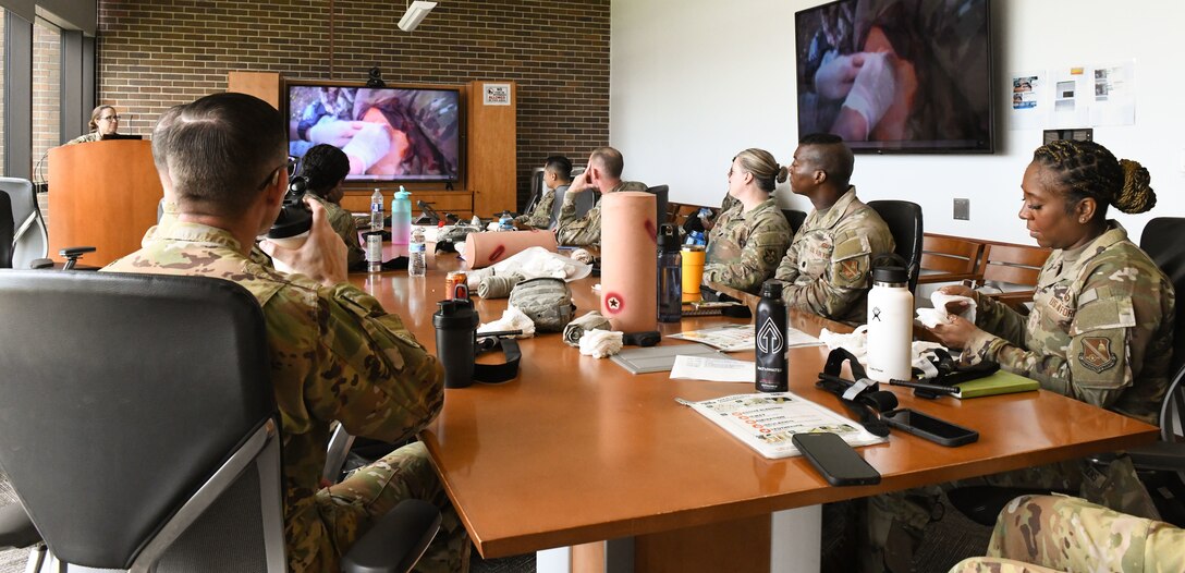 U.S. Airmen assigned to the Air Force District of Washington watch a Tactical Combat Casualty Care training video during AFDW Readiness Day at Joint Base Andrews, Md., July 18, 2025.