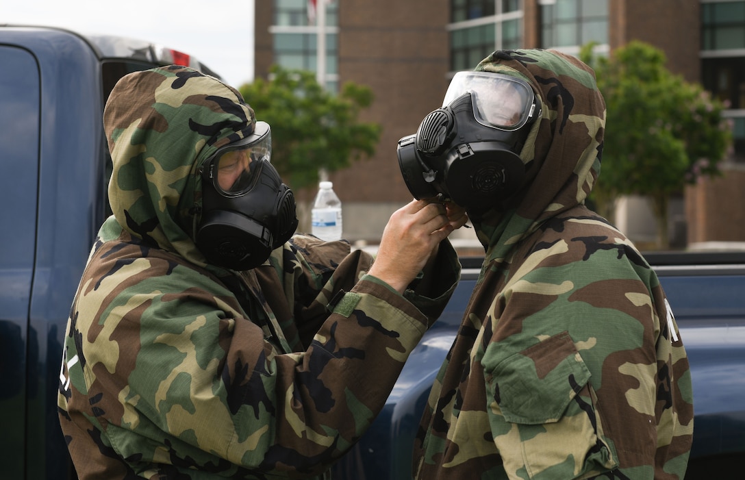 U.S. Airmen assigned to the Air Force District of Washington don Mission Oriented Protective Posture gear during AFDW Readiness Day at Joint Base Andrews, Md., July 18, 2025.
