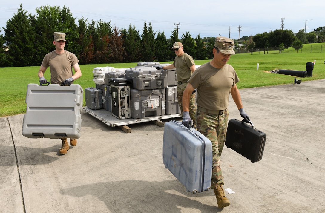 U.S. Airmen assigned to the Air Force District of Washington unload equipment during AFDW Readiness Day at Joint Base Andrews, Md., July 18, 2025.
