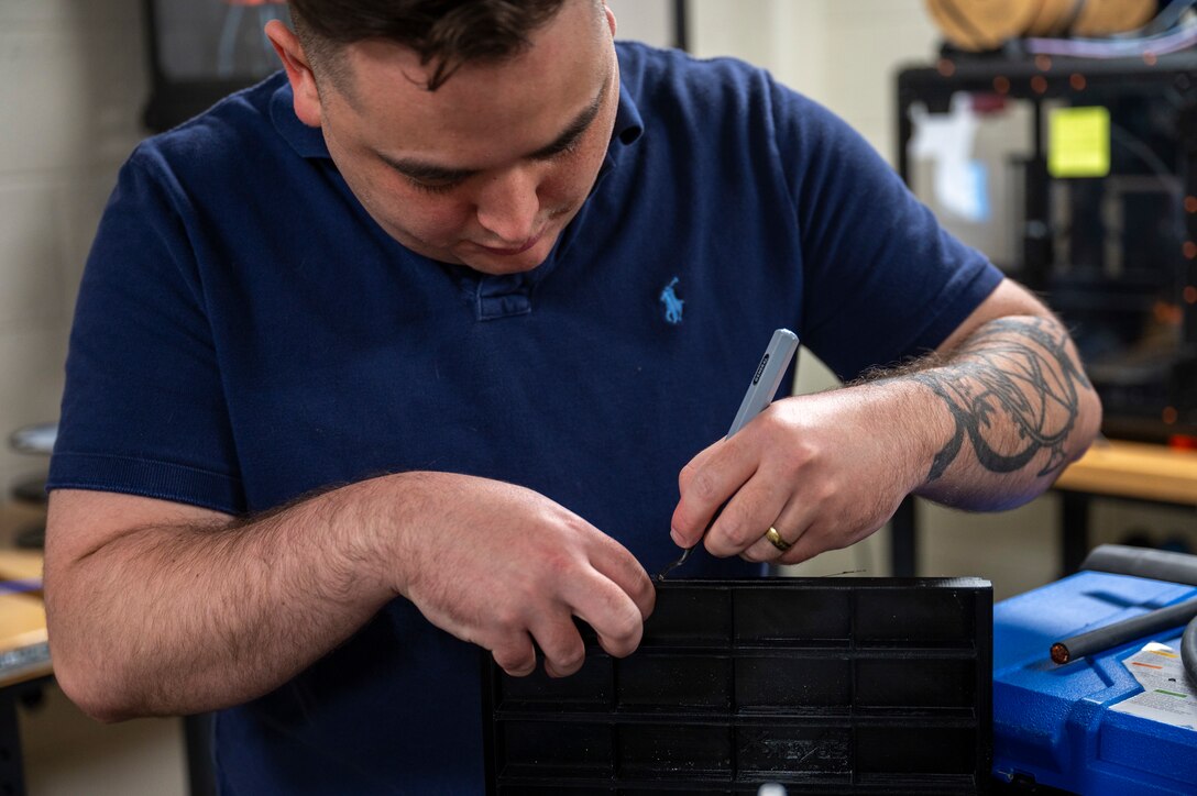 Airman carving a 3D print