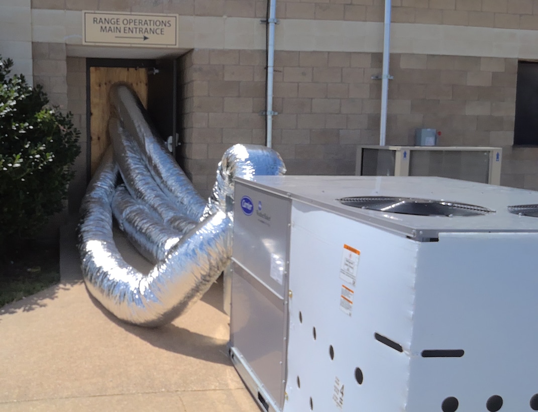 An air conditioning unti pushing air into a building.