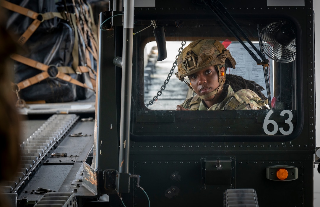 Airman watches cargo being moved