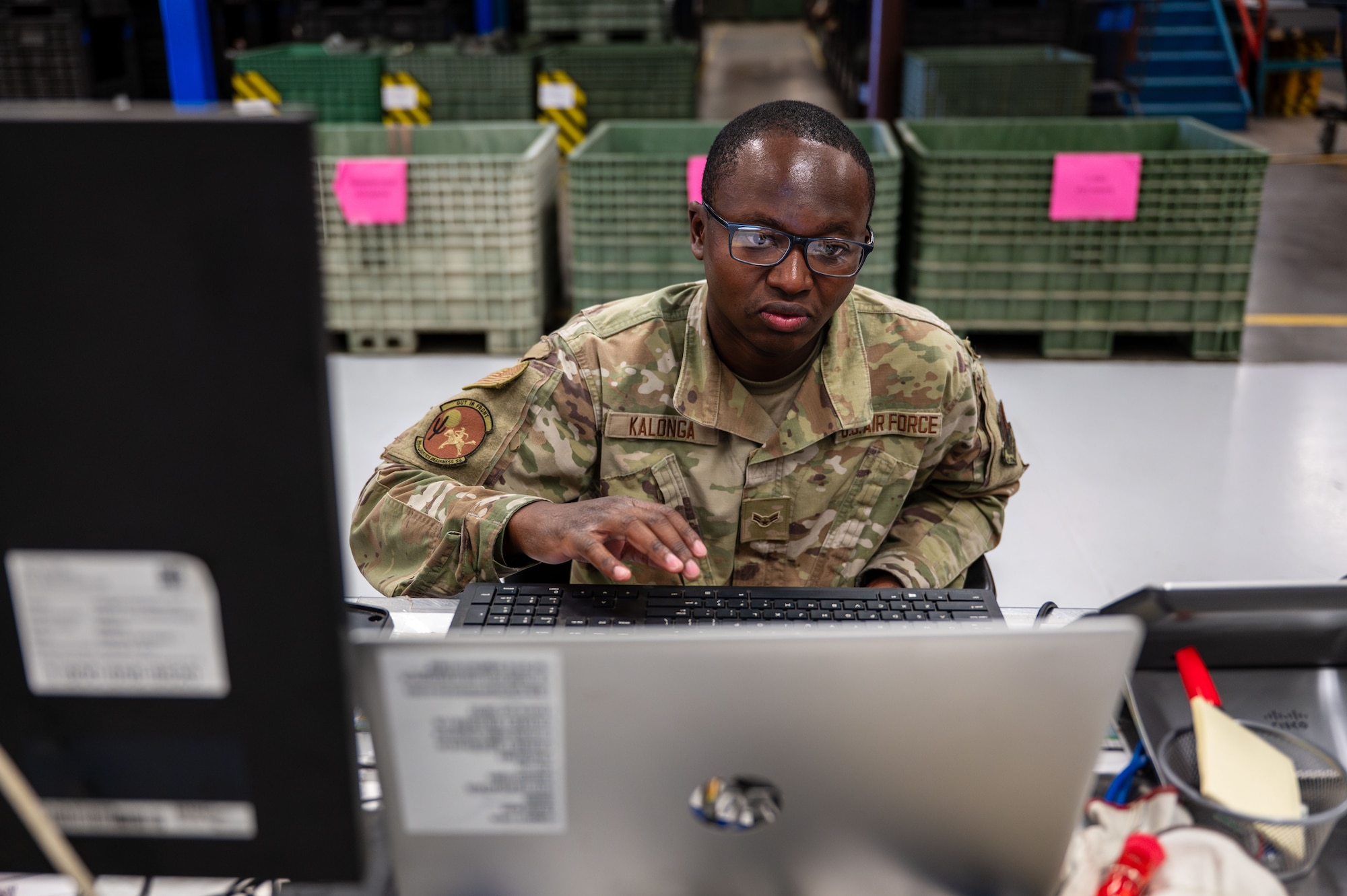 U.S. Air Force Airman 1st Class Steven Kalonga, 355th Logistics Readiness Squadron material manager, uses a computer to log issued gear at Davis-Monthan Air Force Base, Arizona, July 22, 2025. Material managers ensure Airmen are ready for training exercises and real-world operations by issuing proper equipment. (U.S. Air Force photo by Senior Airman Jasmyne Bridgers-Matos)
