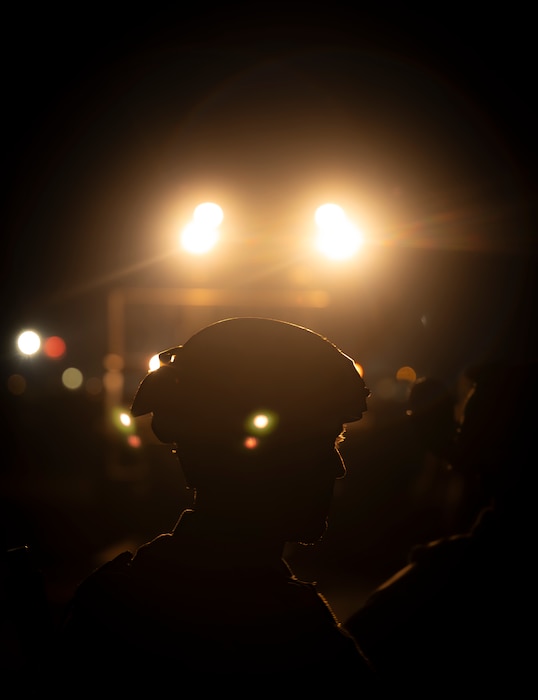 Airman stands in the dark