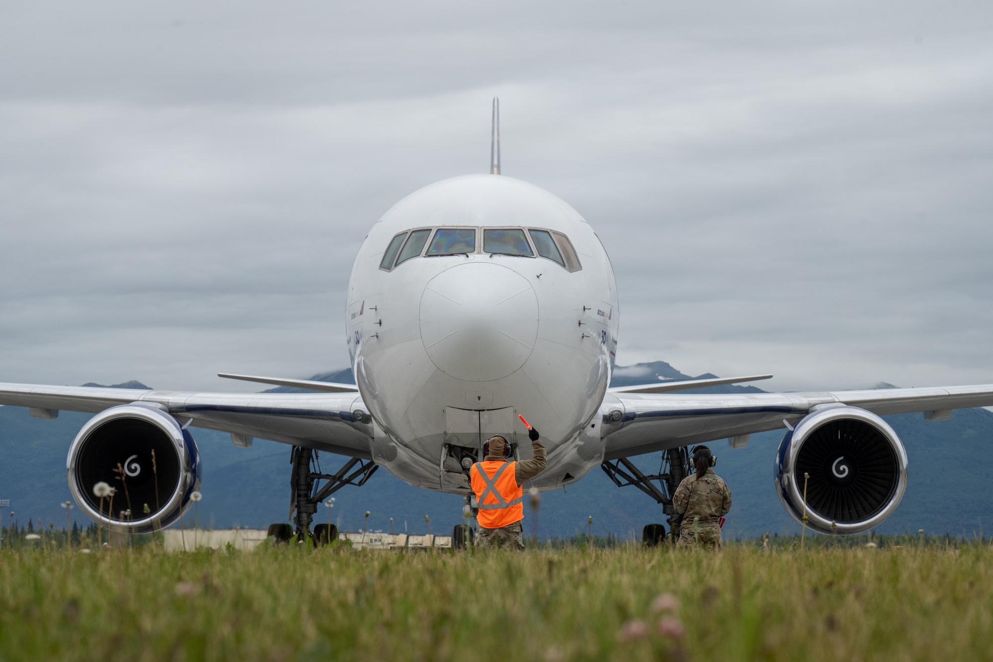 U.S. Air Force Senior Airman Joel Sanchez, avionics journeyman assigned to the 732nd Air Mobility Squadron, marshals an aircraft enroute to support exercise Resolute Force Pacific on Joint Base Elmendorf-Richardson, Alaska, July 13, 2025.