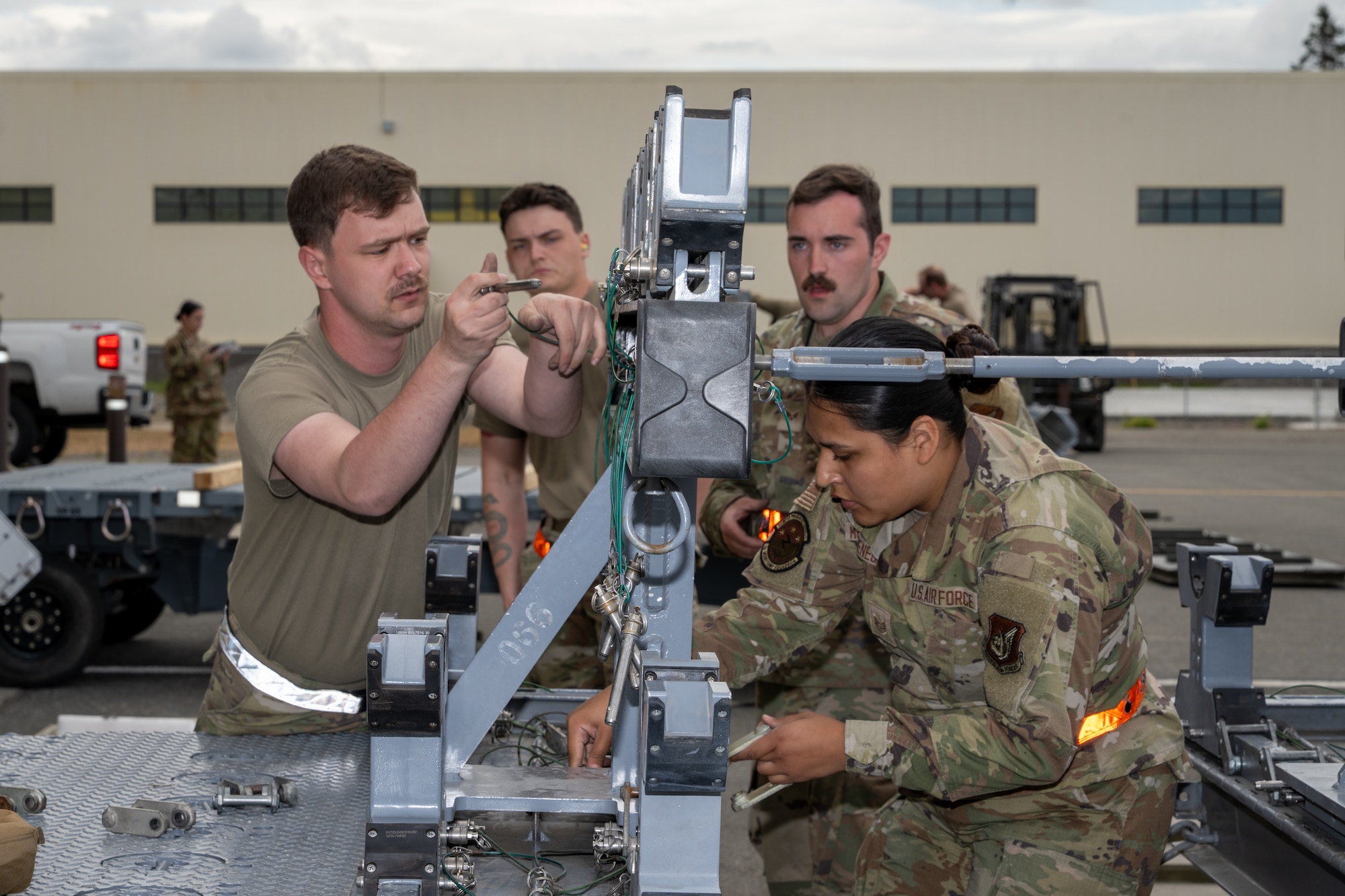 U.S. Air Force Airmen assigned to the 3rd Munitions Squadron assemble munitions during the second quarter mission generation competition at Joint Base Elmendorf-Richardson, Alaska, July 18, 2025.