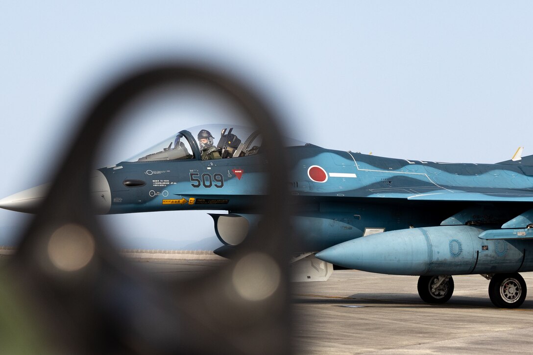 A Japan Air Self Defense Force pilot sits in a JASDF F-2 assigned to 8th Tactical Fighter Squadron, Western Air Defense Force, 8th Air Wing, at Marine Corps Air Station Iwakuni, Japan, during exercise Resolute Force Pacific (REFORPAC) 2025, MCAS Iwakuni, Japan, July 16th, 2025. REFORPAC is part of the first-in-a-generation Department-Level Exercise series, employing more than 400 Joint and coalition aircraft and more than 12,000 members at more than 50 locations across 3,000 miles. (U.S. Marine Corps photo by Cpl. Brian Long)