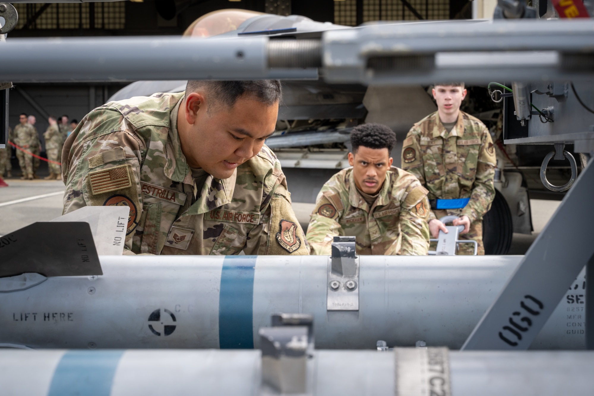 U.S. Air Force Airmen assigned to the 525th Fighter Generation Squadron load munitions onto a weapons loader during the second quarter mission generation competition at Joint Base Elmendorf-Richardson, Alaska, July 18, 2025.