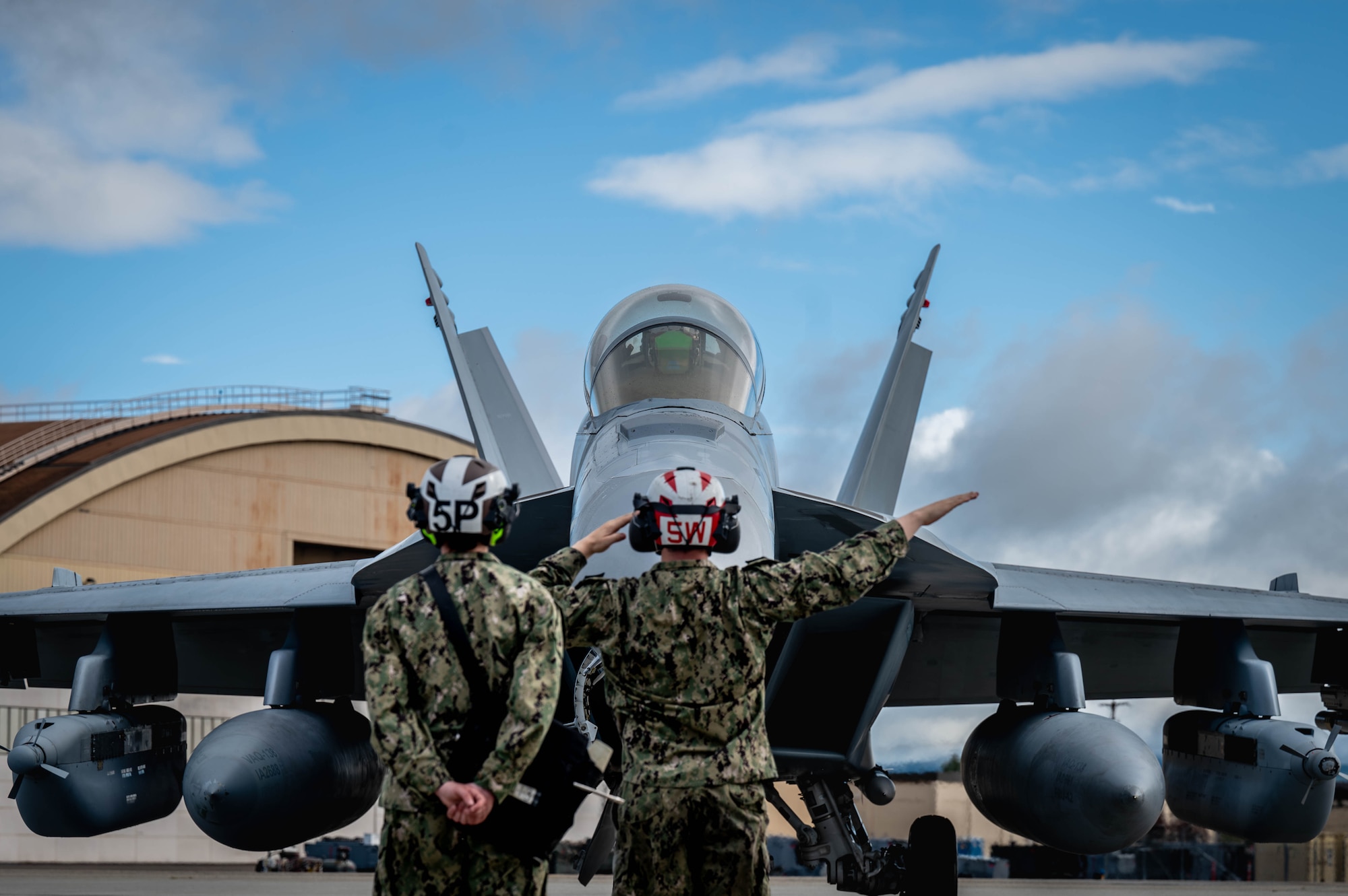U.S. Navy personnel perform pre-flight checks for an EA-18G Growler assigned to the Electronic Attack Squadron (VAQ) 138 before taxiing during Red Flag-Alaska 25-3 at Eielson Air Force Base, Alaska, July 22, 2025.