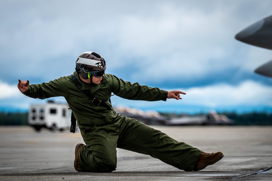 U.S. Navy aviation structural mechanic 3rd class Mike Almengo, Electronic Attack Squadron (VAQ) 138, marshals an EA-18G Growler during Red Flag-Alaska 25-3 at Eielson Air Force Base, Alaska, July 22, 2025.