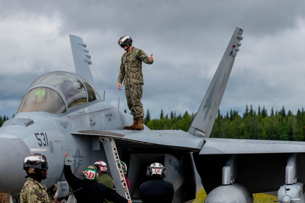 U.S. Navy personnel perform pre-flight checks for an EA-18G Growler assigned to the Electronic Attack Squadron (VAQ) 138 before taxiing during Red Flag-Alaska 25-3 at Eielson Air Force Base, Alaska, July 22, 2025.