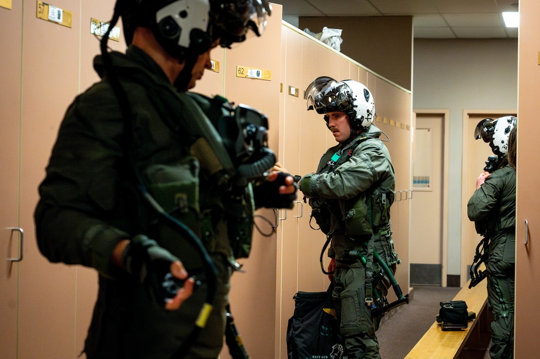 U.S. Marine Corps F-35B Lightning II pilots assigned to Marine Fighter Attack Squadron (VMFA) 12 don their flight gear during Red Flag-Alaska 25-3 at Eielson Air Force Base, Alaska, July 22, 2025.