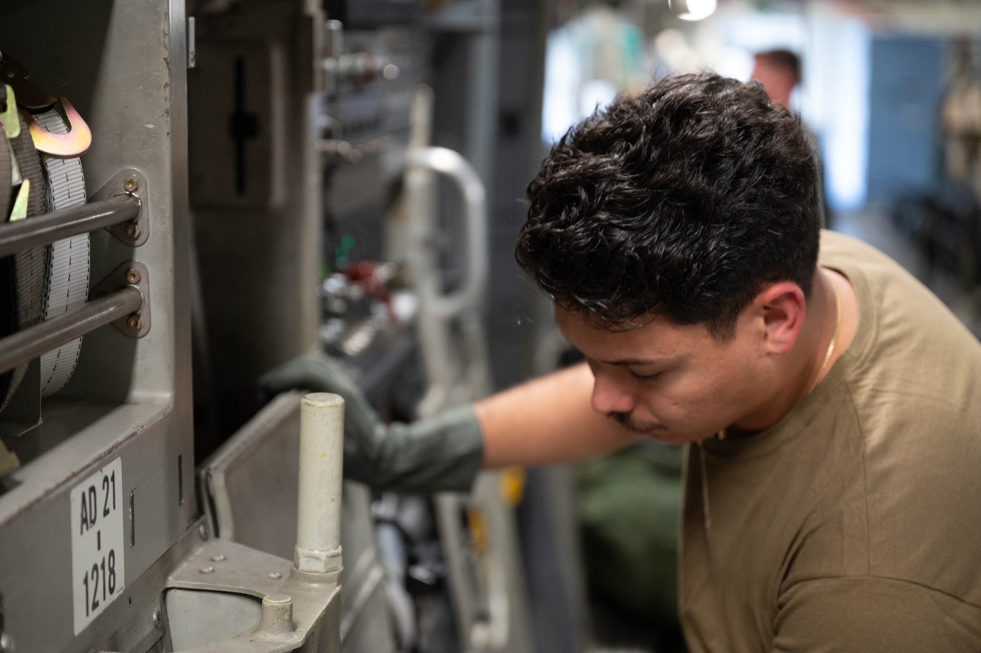 An Airman on a C-17 conducting safety checks.