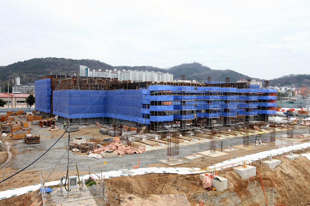 Construction is underway on the new, uniquely designed two-story Vehicle Maintenance Facility (VMF) at Camp Carroll, South Korea. Managed by the U.S. Army Corps of Engineers, Far East District, the $44 million facility includes multiple work bays, integrated workshops, wash bays, and eight bridge cranes. This innovative vertical design maximizes limited space while enhancing maintenance capabilities and logistics support for U.S. Army operations across the Pacific region. (U.S. Army photo by Yo Kyong-il)