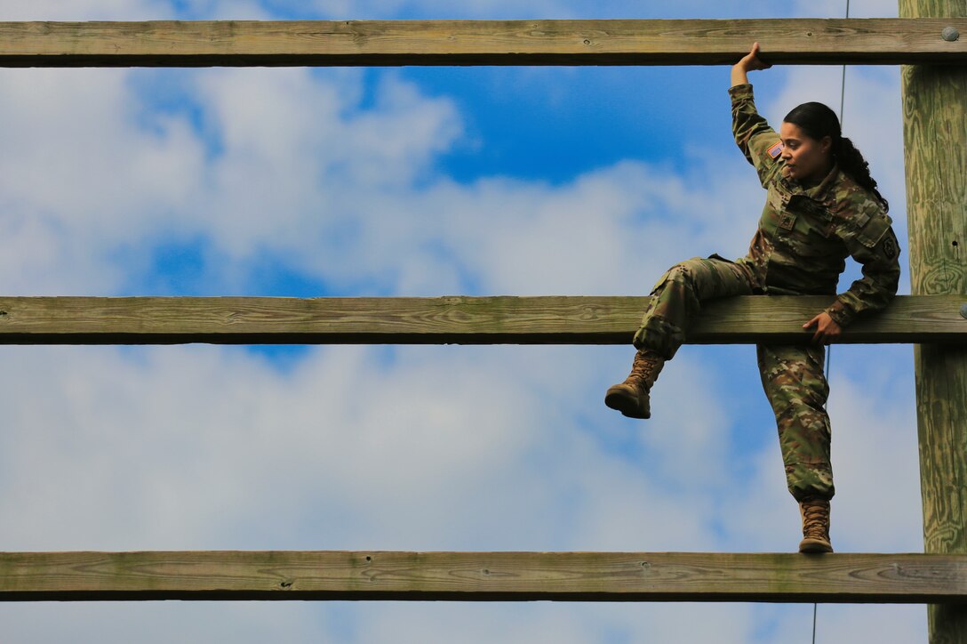U.S. Army Staff Sgt. Melyssa Vazquez, a public affairs specialist with the 213th Regional Support Group, Pennsylvania National Guard, scales an obstacle on the confidence course at Fort Indiantown Gap, Pennsylvania, July 22, 2025.