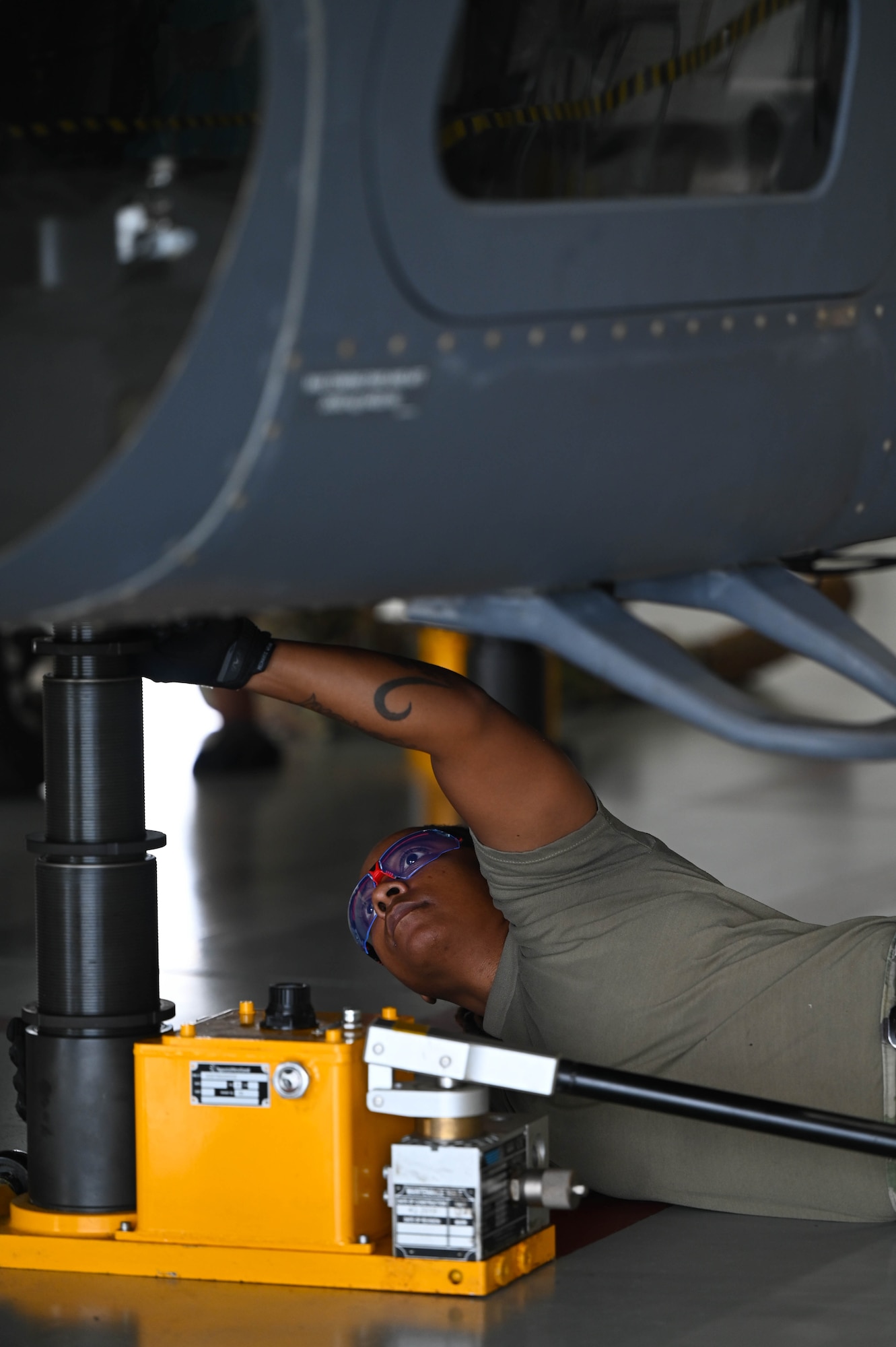 a person works on a helicopter