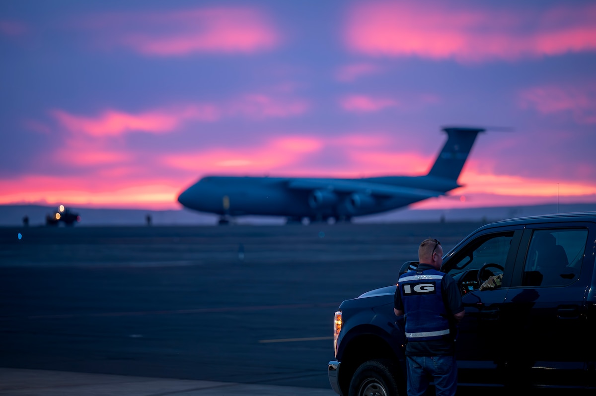 Man talks with another at sunset