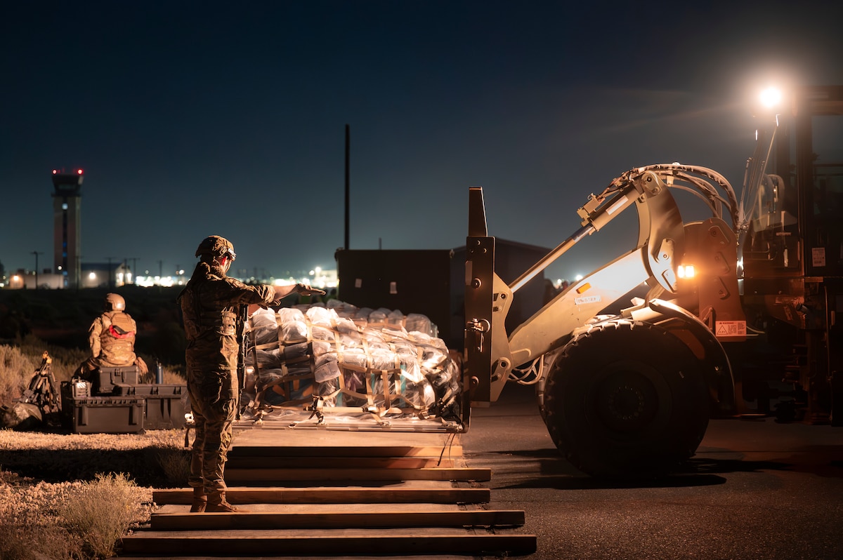 Airmen work together to move cargo